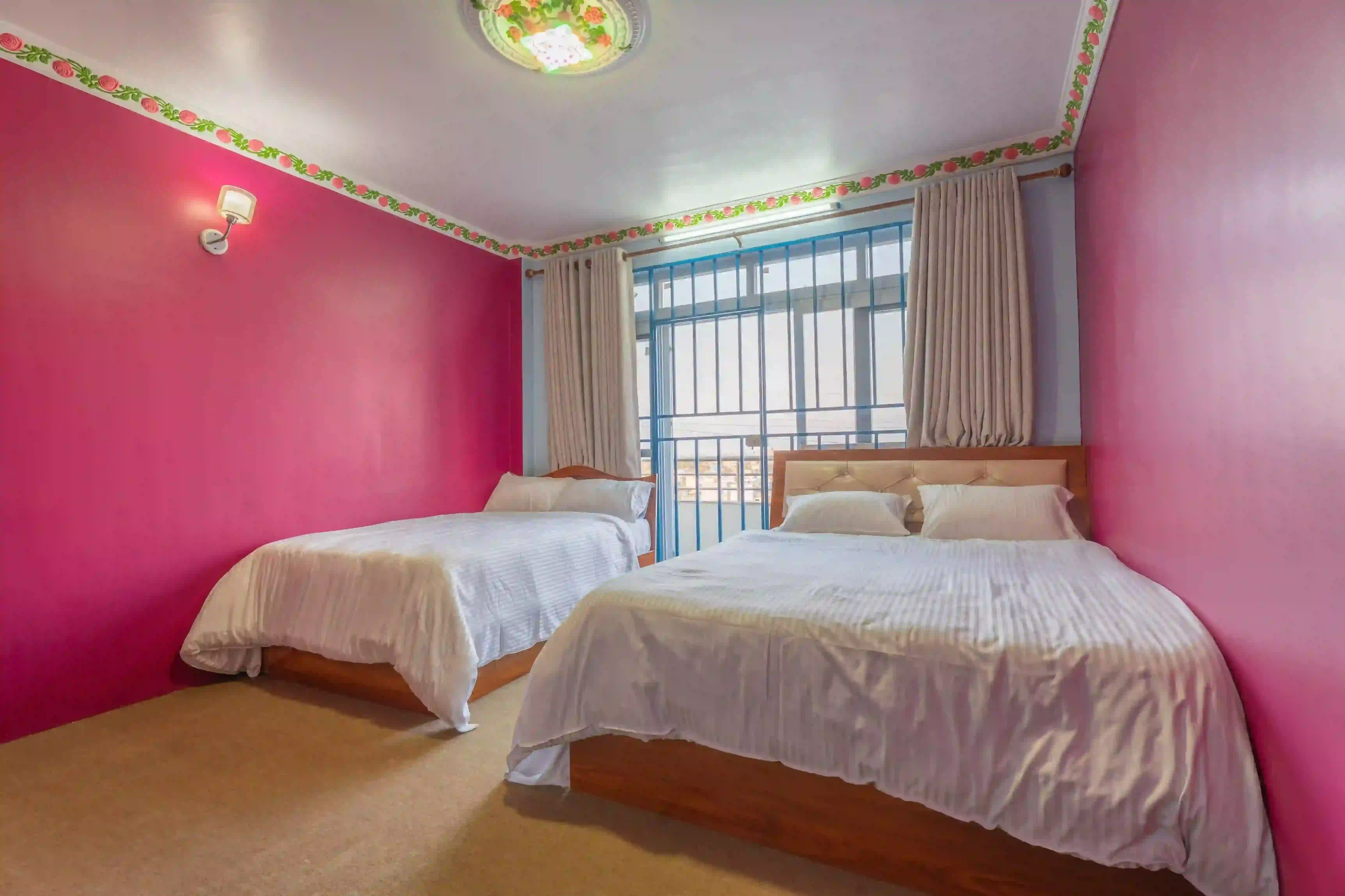 Deluxe room with comfortable bedding at Aananda Homestay